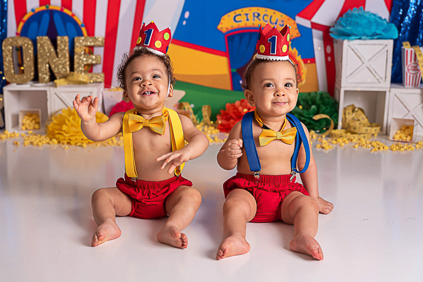 twin boys smiling with their circus outfits in cake smash akron childrens hospital pediatrics