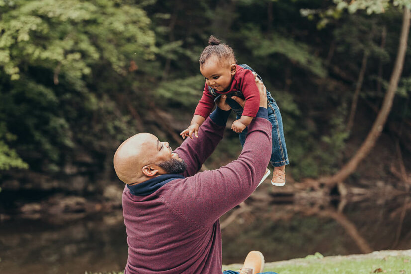 little boy in denim overalls and red shirt being lifted in the air by his dad things to do in northeast Ohio with kids