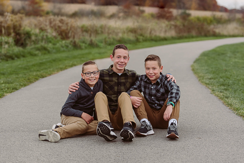 once upon a child ohio locations for 3 boys sitting on ground during family portrait session