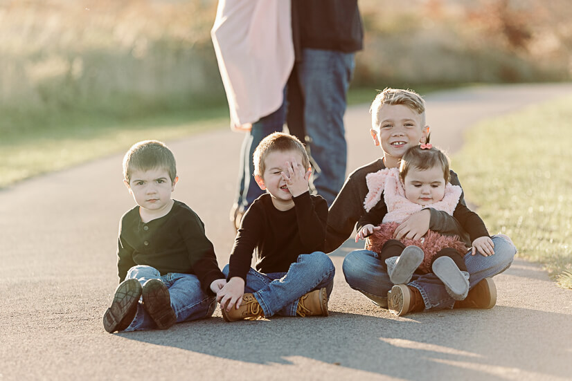 kids sitting in park, son making funny face for things to do in youngstown with kids