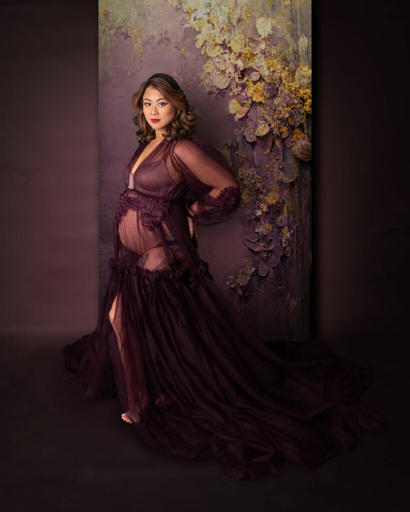 Mother posing during purple and gold photography session with Cleveland Maternity Photographer