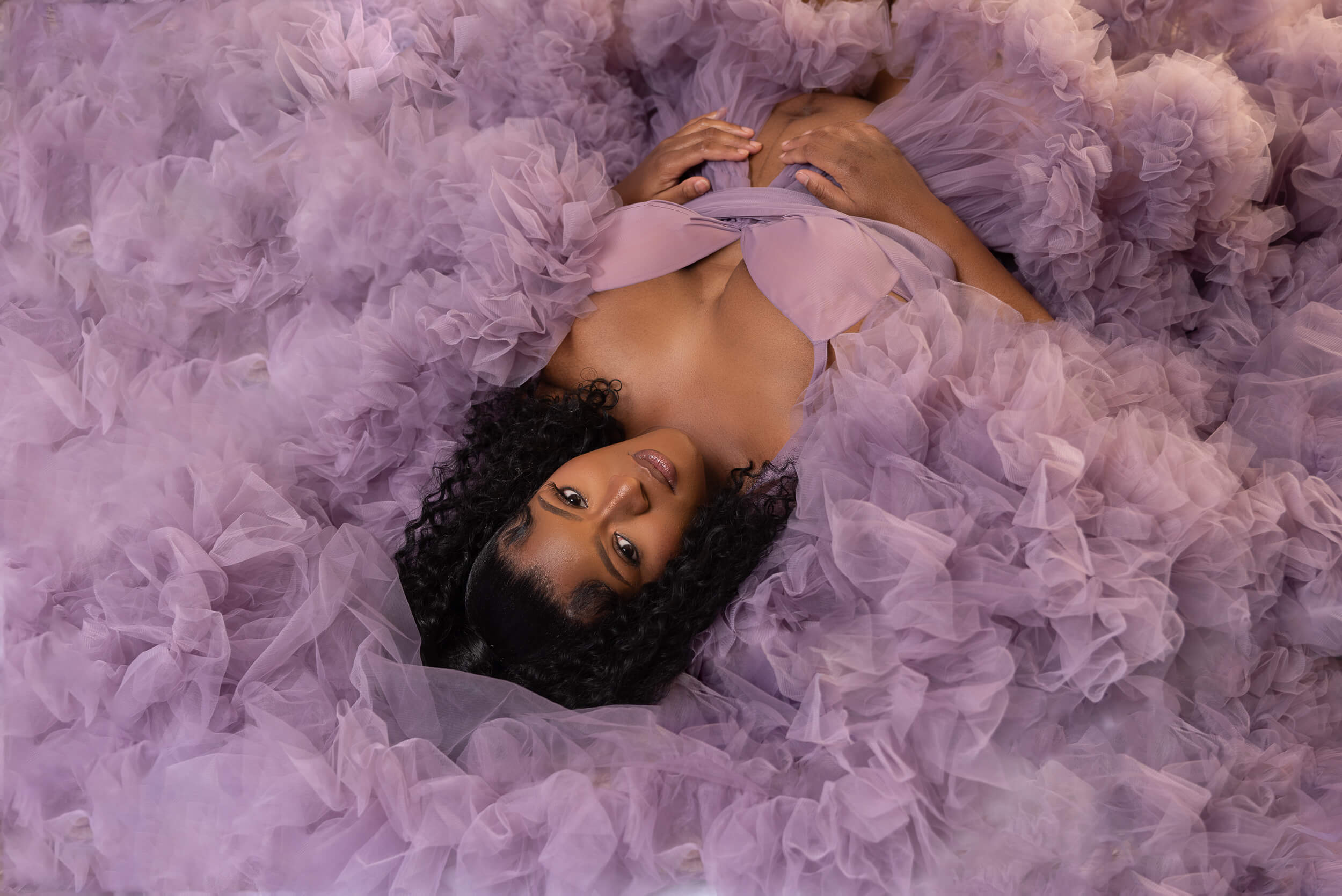 Mother lying in ground with a purple dress Cleveland Maternity Photography