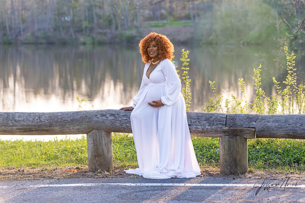 Mother sitting in park during maternity photo session Dr. Desalvo Warren Ohio