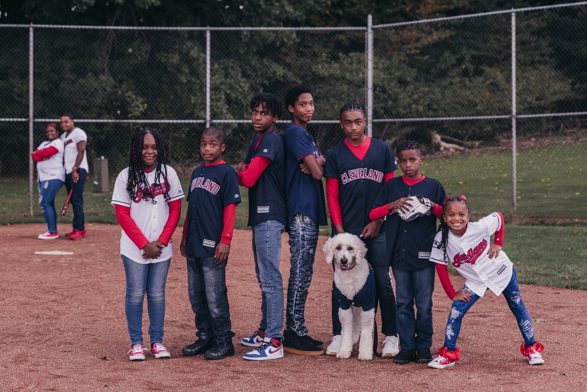 Family dressed in baseball outfits during a photography session lakeshore learning