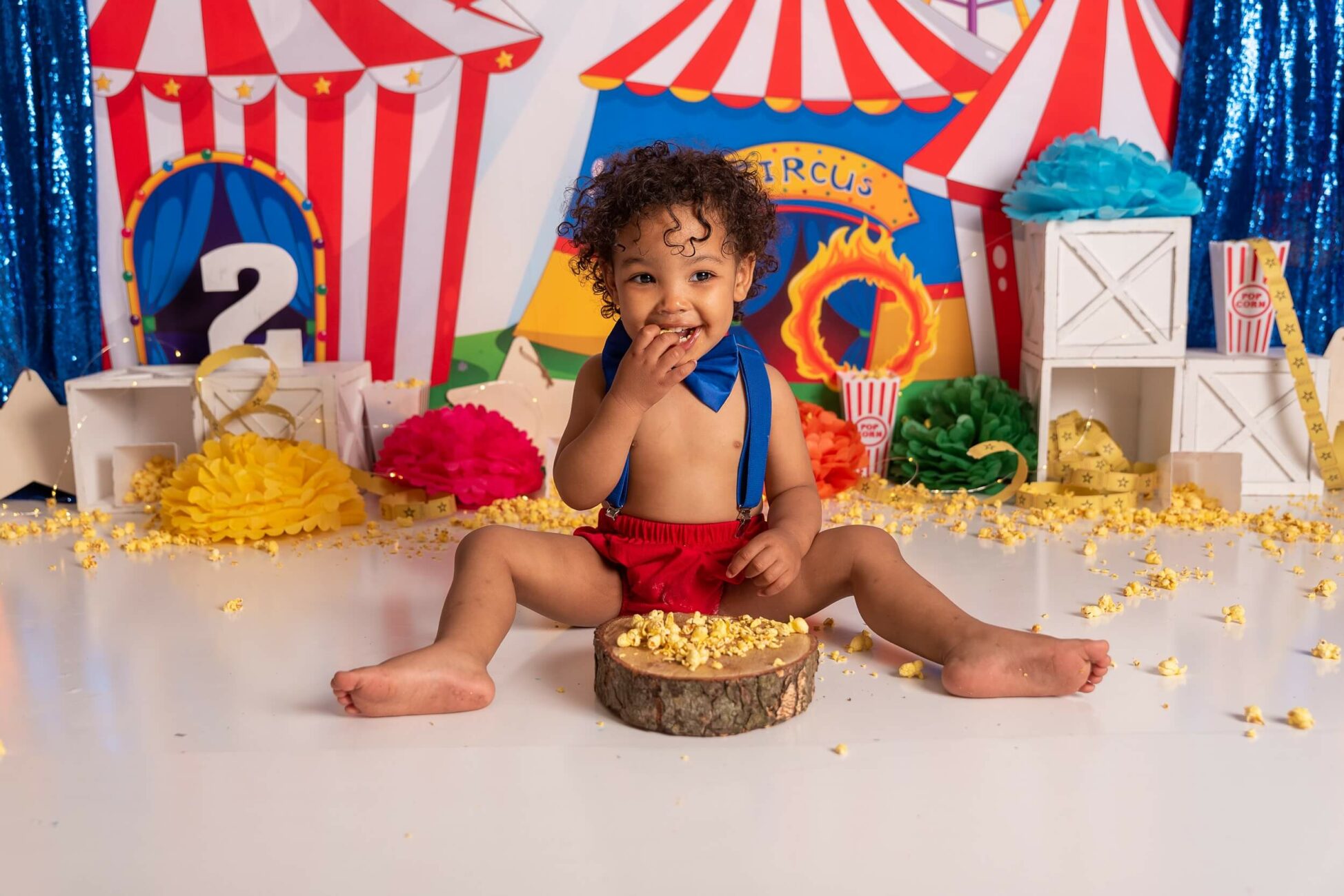 child sitting in a carnical theme cake smash set for Tadpoles & Tiddlers
