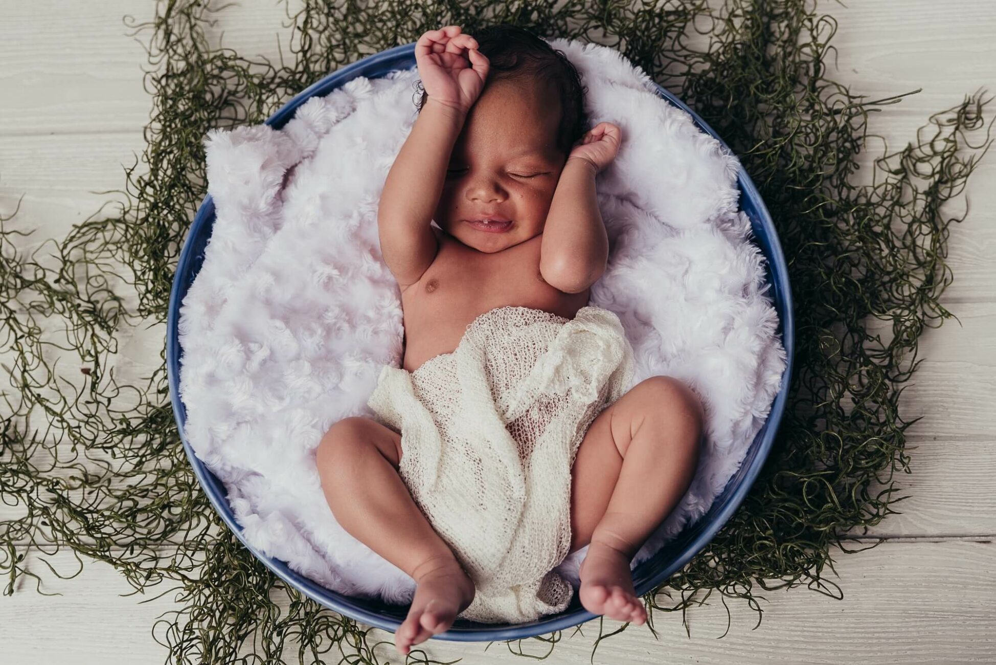 newborn in a flower bowl for Cherub's Blanket