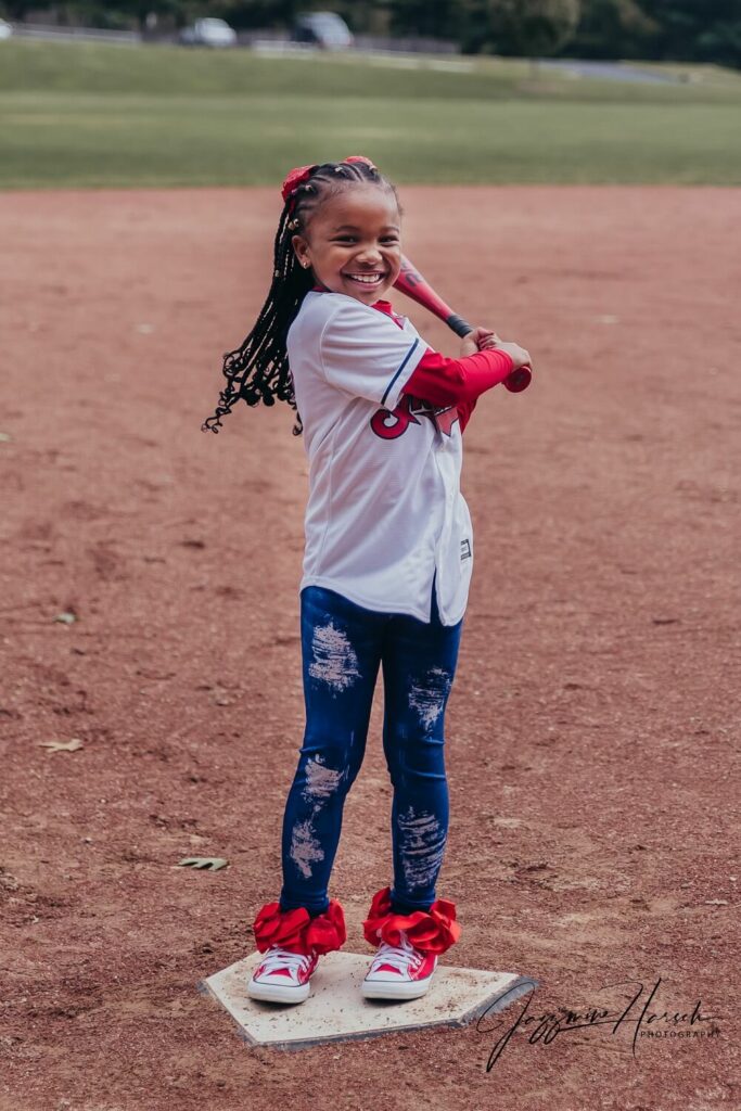 daughter swinging baseball smiling Rocky River Nature Center