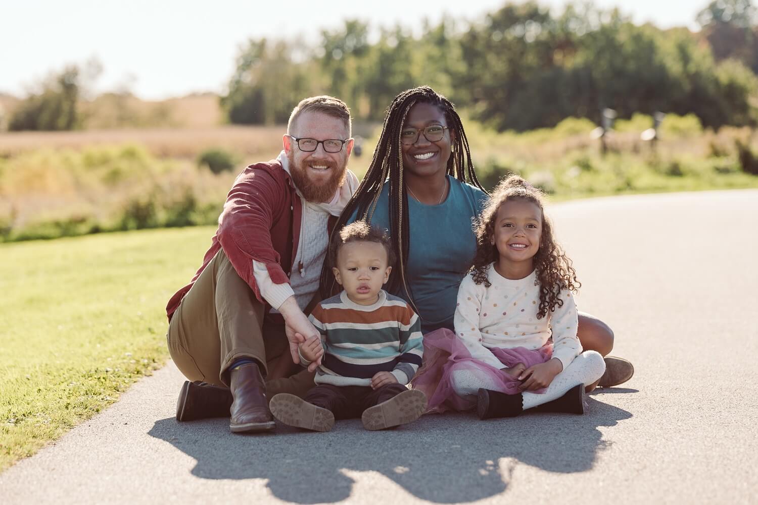 family of 4 sitting on ground at millcreek metroparks farm Fun Fun Family activites for northeast and cleveland ohio family photographer