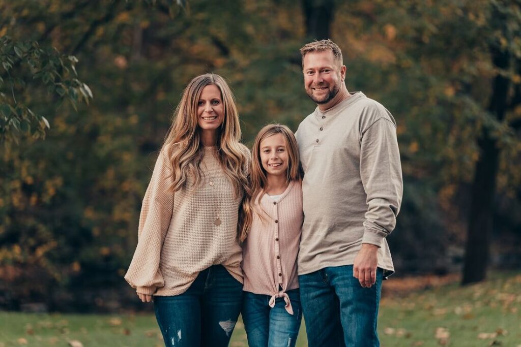 A family portrait in an outdoor fall setting featuring a mother, father, and young daughter smiling at the camera Fun Activities for 9-11 Year Olds