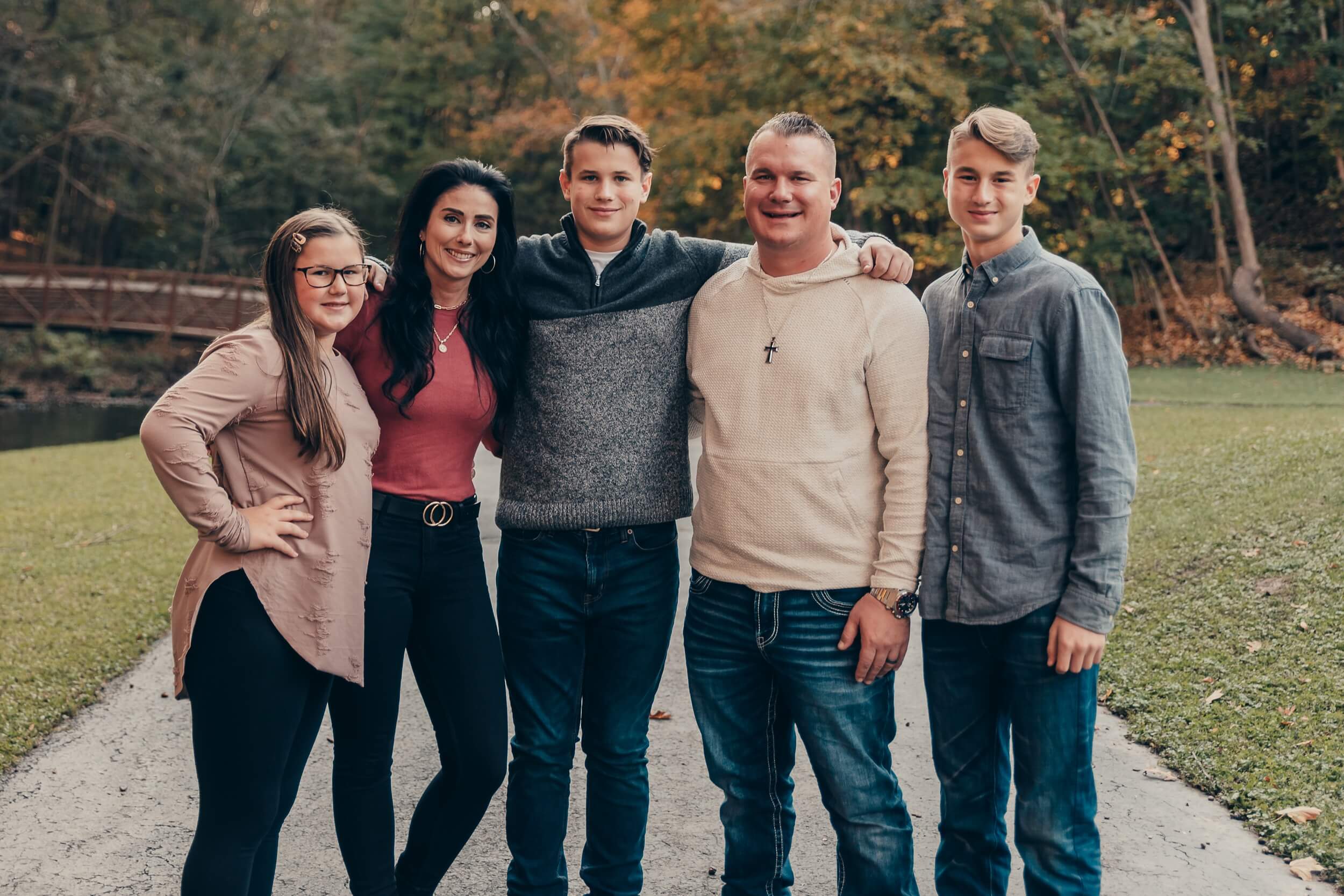 Family of five smiling together during a fall family photo session in Northeast Ohio