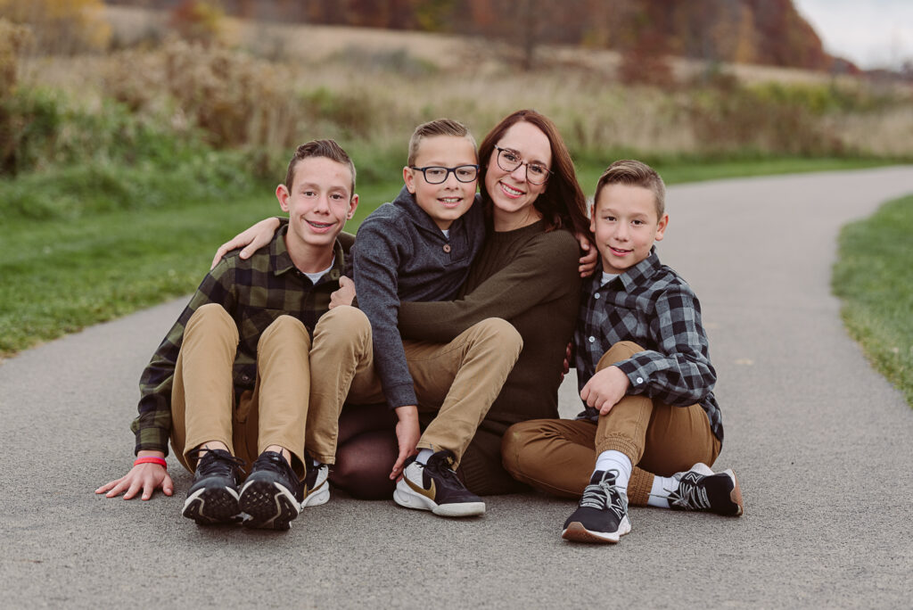 Mom with her three sons during an outdoor fall family photography session in Northeast Ohio