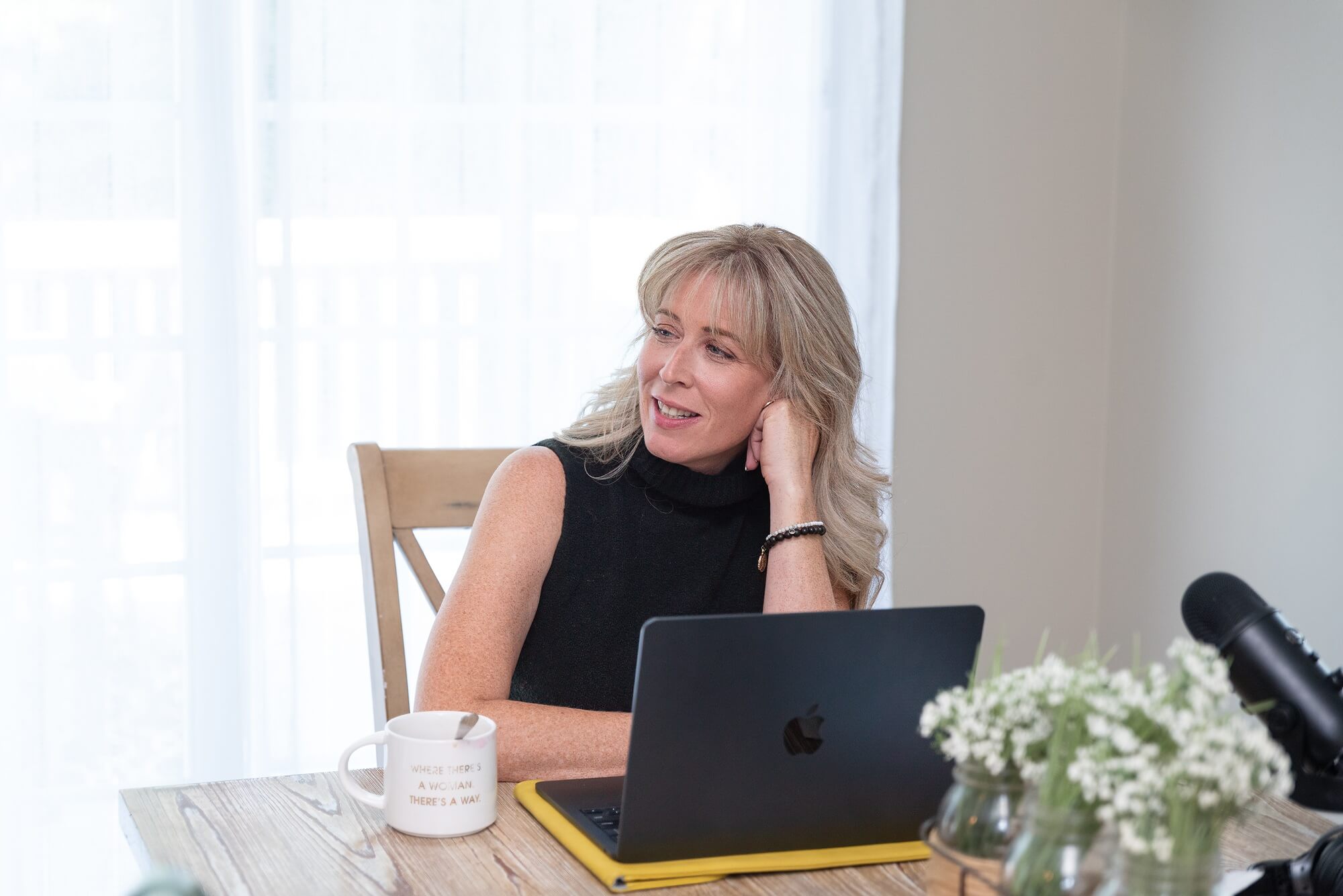 Woman working on a laptop during a personal brand photography session for a Northeast Ohio small business owner